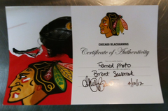 This framed photograph was a gift to 2012 Chicago Blackhawks season ticketholders.  The work is autographed by Hawks' defenseman Brent Seabrook, and includes a certificate of authenticity.  Dimensions:  15.5" x 22" framed.