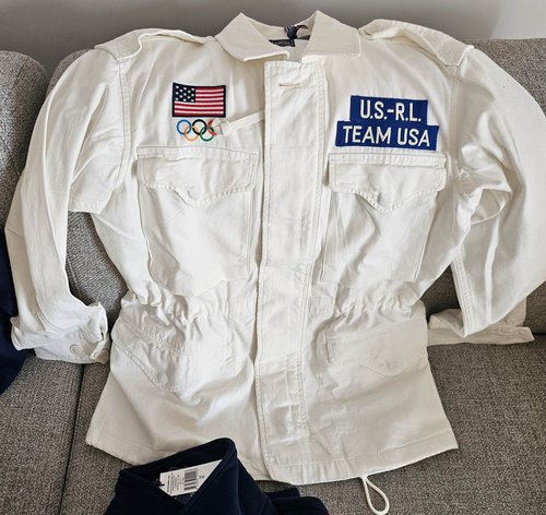 Part of the Polo Ralph Lauren Team USA Collection, this twill field jacket combines utility-inspired details, such as patch pocketing and shoulder epaulets, with signature embroidery that includes a historical American flag and the Olympic Rings.  Orders for this product will ship 9/14/24.  Expedited orders can be shipped as soon as possible, for an additional $100.