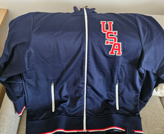 Part of the Polo Ralph Lauren Team USA Collection, this track jacket features an official logo patch of the U.S. Olympic Team and the legendary designer's signature embroidered Pony.  Made with a cotton blend, this double-knit layer draws inspiration from vintage basketball warm-up suits.  Orders for this product will ship 9/14/24.  Expedited orders can be shipped as soon as possible, for an additional $100.